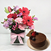 Lovely Mixed Flowers In Glass Vase With Cake
